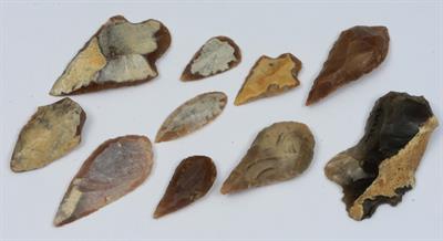 Lot 246 - TEN BRITISH NEOLITHIC FLINTS comprising nine arrowheads and one scraper marked Ewell by repute Ex: B