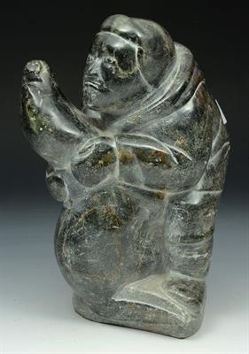 Lot 284 - AN INUIT SOAPSTONE CARVING of a hunter grappling with a seal