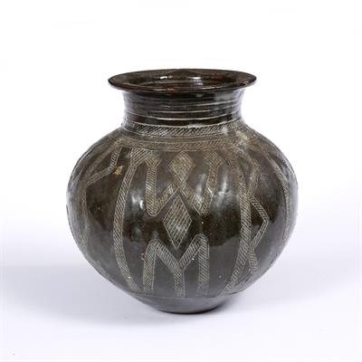 Lot 382 - LAMI TOTO (20TH CENTURY)  A Gwari brown glazed storage jar with stylised decoration