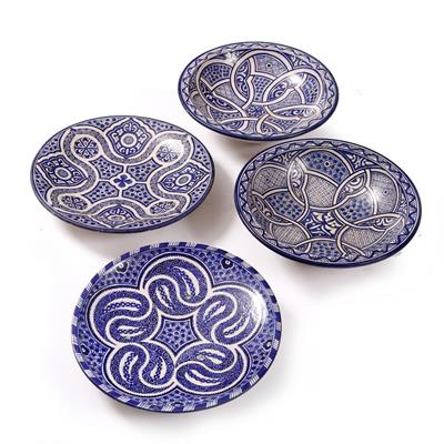 Lot 385 - A GROUP OF FOUR MIDDLE EASTERN BLUE AND WHITE POTTERY DISHES/BOWLS with stylised decoration