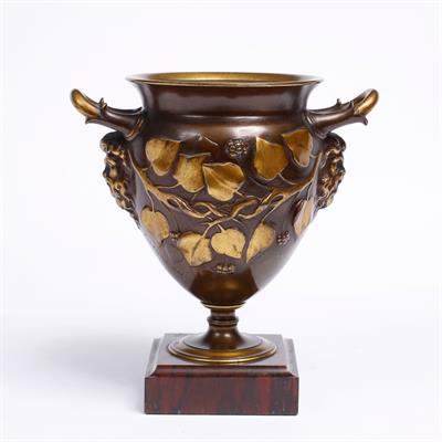 Lot 401 - A FRENCH BRONZE TWO HANDLED URN with gilded ivy leaf and mask decoration signed F. Levillain on a sq