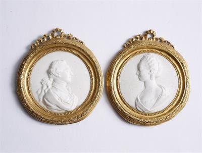 Lot 406 - A PAIR OF 18TH CENTURY FRENCH WHITE BISQUE PORCELAIN RELIEF MINIATURE PORTRAITS in gilt metal frames