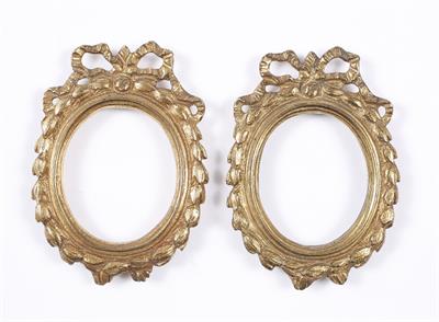 Lot 407 - A PAIR OF GILDED METAL OVAL MINIATURE FRAMES in the manner of Matthew Boulton with ribbon swag surro