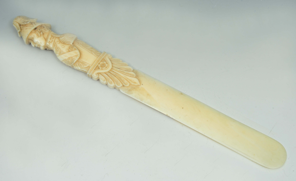 Lot 661 - AN ANTIQUE IVORY PAGE TURNER carved with a silhouette handle in the form of the Duke of Wellington