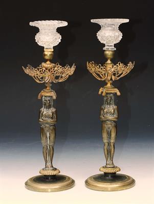 Lot 234 - A PAIR OF EGYPTIAN REVIVAL BRONZE AND GILT METAL CANDLESTICKS