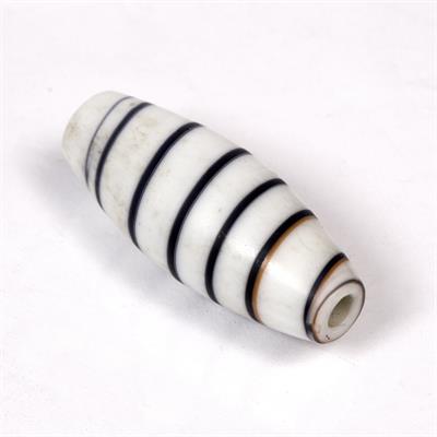 Lot 425 - A LARGE TUBULAR WHITE GLASS BEAD