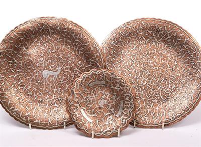 Lot 205 - A PAIR OF ISLAMIC COPPER AND SILVER INLAID PLATES