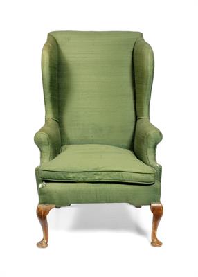 Lot 22 - A GEORGE III WING BACK ARMCHAIR with green silk upholstery and cabriole front legs terminating in pa