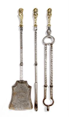 Lot 27 - A SET OF THREE OLD STEEL AND BRASS FIRE IRONS the finials each mounted with the head of a youth