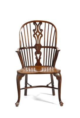 Lot 51 - A GEORGE III YEW WOOD AND ELM WINDSOR ARMCHAIR with flower carved and pierced splat and further spin