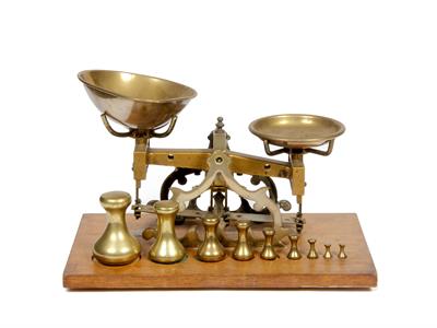 Lot 228 - A SET OF BRASS FRAMED SCALES on a mahogany veneered plinth base