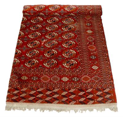 Lot 244 - A TEKKE TURKMEN RED GROUND SMALL CARPET with central geometric decoration within a typical border