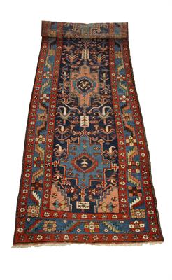 Lot 245 - AN ANTIQUE NORTH WEST PERSIAN HERIZ BLUE GROUND RUNNER with five geometric designed to the central f