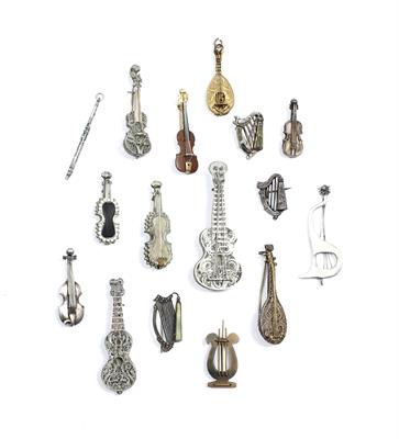 Lot 295 - FOUR CONTINENTAL WHITE METAL FILIGREE BROOCHES in the form of musical instruments