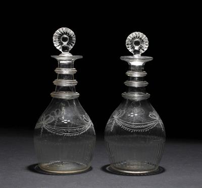 Lot 324 - A PAIR OF GEORGIAN IRISH THREE RING DECANTERS with moulded stoppers and engraved ribbon tied swag de