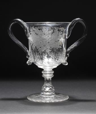 Lot 381 - A VICTORIAN TWO HANDLED GLASS LOVING CUP with flower engraving and facet cut decoration to the bowl