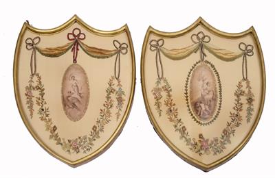 Lot 425 - A PAIR OF 19TH CENTURY REGENCY STYLE SILK EMBROIDERED SHIELD SHAPE PANELS each decorated with a cent