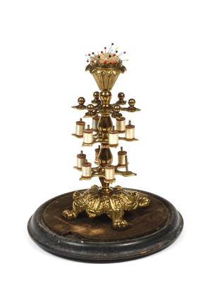 Lot 454 - A VICTORIAN CAST AND PIERCED BRASS THREAD STAND with pin cushion top and posts for various small ree