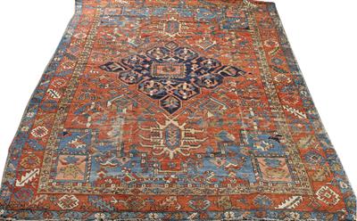 Lot 464 - AN ANTIQUE HERIZ BRICK GROUND LARGE RUG with central blue ground diamond motif to the centre