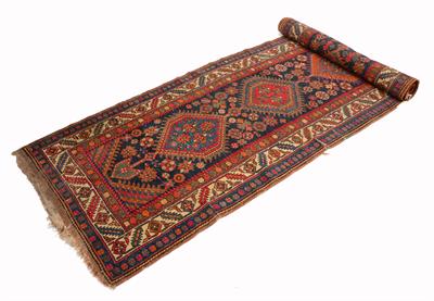 Lot 478 - A NORTH WEST PERSIAN BLUE GROUND RUNNER with a central design of interlinked polychrome medallions w