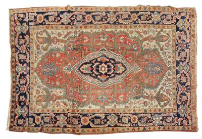 Lot 479 - A HERIZ CARPET with a central large blue ground medallion in a rust field of scrolling flowers and w