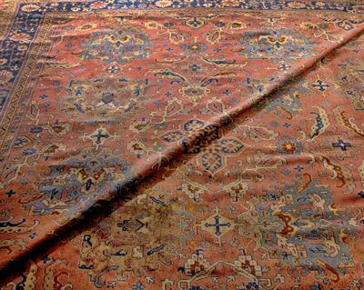 Lot 516 - A LARGE EARLY 20TH CENTURY MIDDLE EASTERN PINK AND BLUE GROUND CARPET with multiple stylised motifs