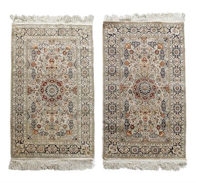 Lot 517 - A NEAR PAIR OF ORIENTAL SILK WHITE GROUND RUGS each with stylised foliate decoration