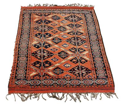 Lot 547 - A MID 20TH CENTURY MIDDLE EASTERN RED GROUND RUG decorated with interlinked medallions and a banded