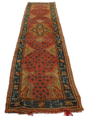 Lot 548 - AN ANTIQUE TURKISH RED AND GREEN GROUND RUNNER with a central motif and a banded border with stylise