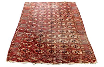 Lot 551 - AN ANTIQUE RED GROUND BOKHARA RUG the central field decorated with five rows of medallions within a