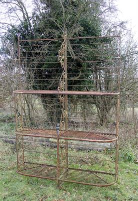 Lot 603 - A 19TH CENTURY FRENCH WROUGHT IRON BREAD RACK with three shaped shelves and with scrolling bracket s