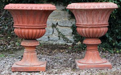 Lot 607 - A PAIR OF OLD TERRACOTTA GARDEN PLANTERS of urn form with acanthus leaf moulded rims