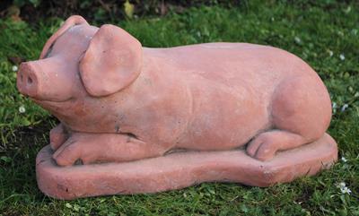 Lot 608 - A RECUMBENT TERRACOTTA PIG