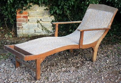 Lot 625 - AN OLD TEAK RATTAN UPHOLSTERED GARDEN LOUNGER CHAIR 70cm wide x approximately 176cm long