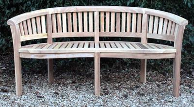 Lot 629 - A TEAK GARDEN BENCH of curved form with a slatted back and seat and square legs 156cm wide