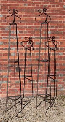 Lot 651 - A PAIR OF WROUGHT IRON TRIANGULAR GARDEN OBELISKS with scrolling finials