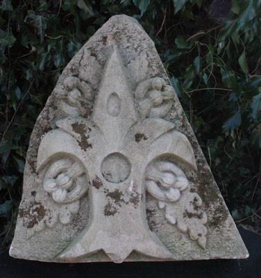 Lot 659 - A HAND CARVED STONE ARCHITECTURAL ELEMENT with a fleur de lys pattern 43cm wide x 43cm high