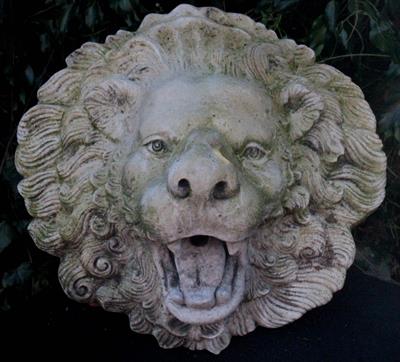 Lot 672 - A CAST COMPOSITE STONE LION FOUNTAIN MASK FOUNTAIN with copper pipe 38cm wide