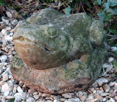 Lot 675 - A CAST STONE SCULPTURE of a frog sitting on a rock