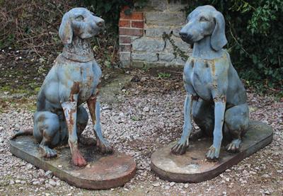 Lot 684 - A PAIR OF GREY PAINTED CAST IRON SEATED HOUNDS one with a collar