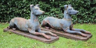 Lot 692 - A PAIR OF GREY PAINTED CAST IRON HOUNDS resting but alert and on rectangular bases with canted corne