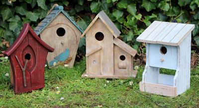 Lot 695 - A GROUP OF FOUR WOODEN BIRD HOUSES OR BOXES