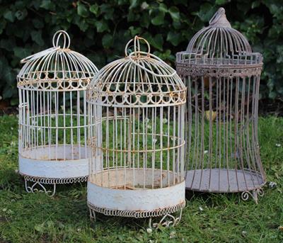 Lot 699 - A PAIR OF WHITE PAINTED WIRE WORK CYLINDRICAL BIRD CAGES with suspension loops and each with three s