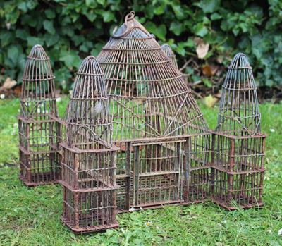 Lot 700 - A DOMED WIRE WORK BIRD CAGE with four outset domed towers to each corner