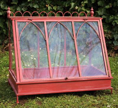 Lot 701 - A RED PAINTED TIN TABLE TOP TERRARIUM with cast finials and with a hinged fall front