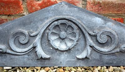 Lot 705 - AN OLD CONTINENTAL ZINC PANEL of triangular form with central flower head surrounded by scrolling ac