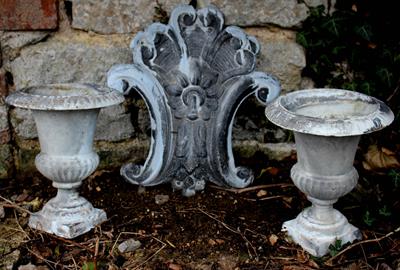 Lot 711 - A DECORATIVE ZINC PANEL with flower head and scroll decoration 40cm high together with a pair of sma