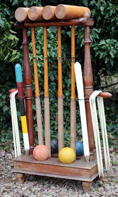 Lot 719 - AN OLD CROQUET SET on a hardwood stand with four mallets