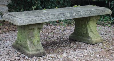 Lot 723 - AN OLD RECONSTITUTED STONE RECTANGULAR TOPPED GARDEN BENCH with scroll and acanthus leaf decorated s