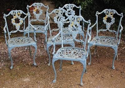 Lot 726 - A SET OF SIX CAST ALUMINIUM GARDEN OPEN ARMCHAIRS painted blue and with scroll decoration and standi